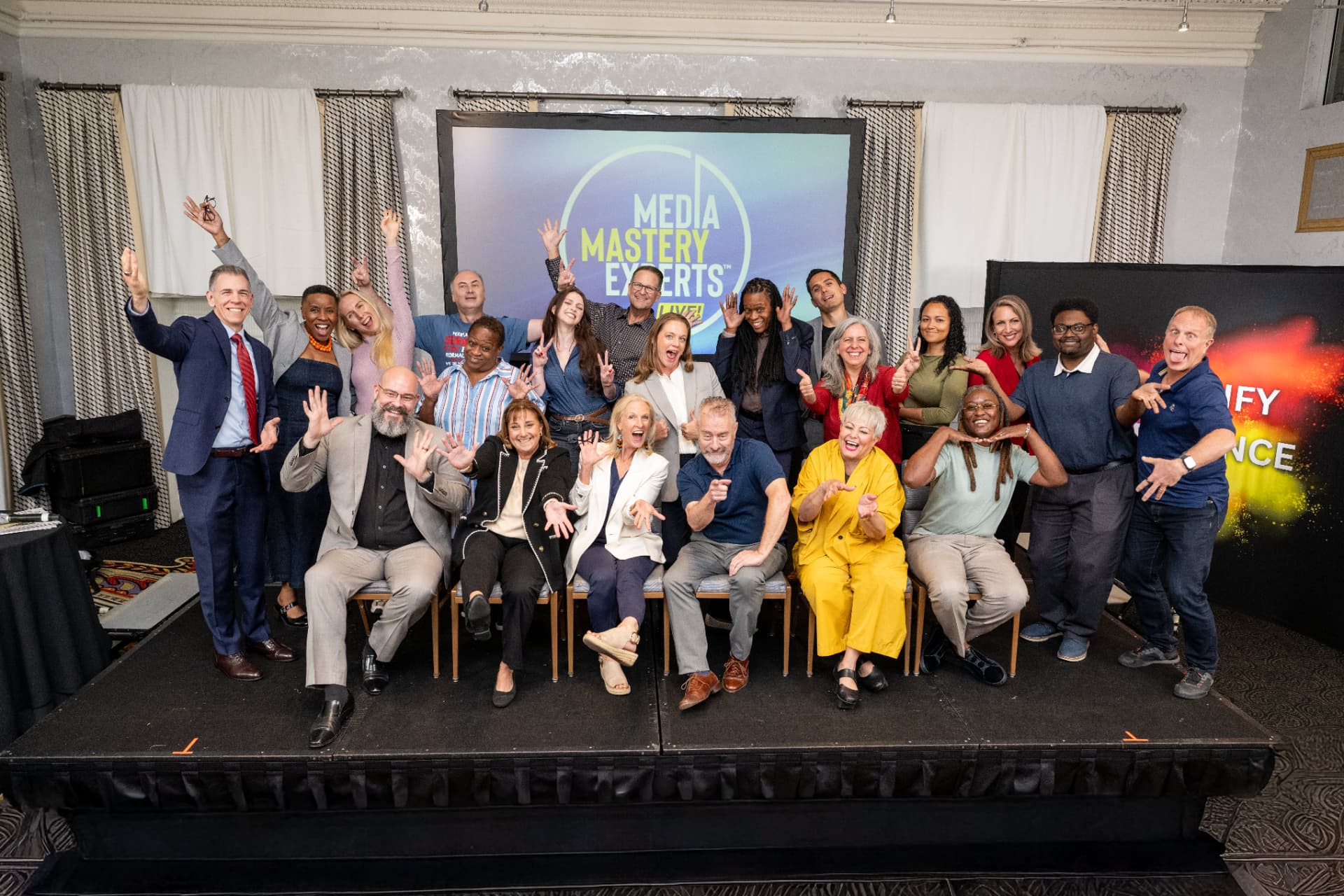Media Mastery Experts participants celebrating together on stage